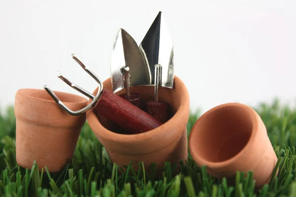 Gardening tools in pots — Stock Photo, Image