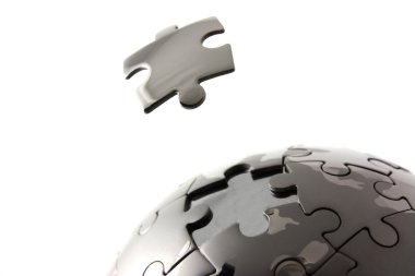 Puzzle globe with floating piece clipart