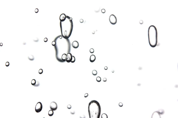 Buborékok, egy fehér háttér — Stock Fotó