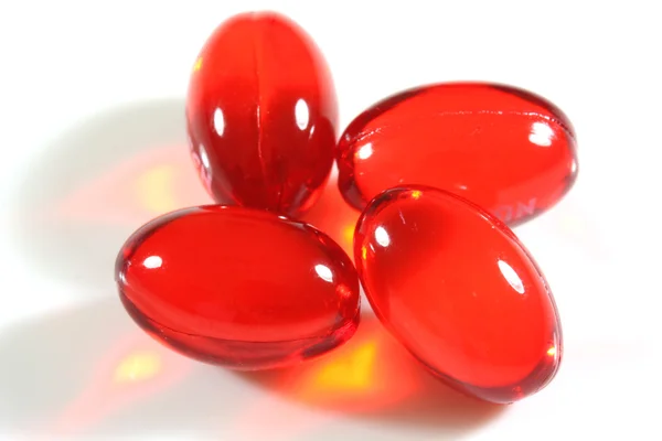 Cuatro píldoras rojas —  Fotos de Stock