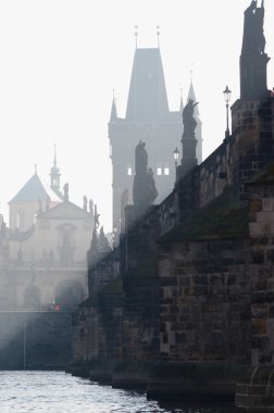 Charles bridge in the early morning fog clipart