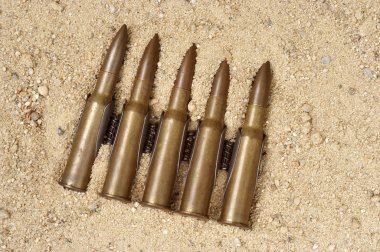 Ammunition on the sand clipart