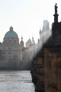 Charles bridge in the early morning fog clipart