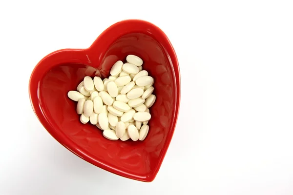 Bright red heart and medicines — Stock Photo, Image