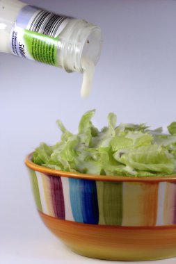 Bowl of salad with dressing clipart