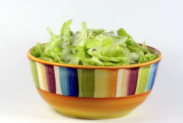 Bowl of salad with dressing — Stock Photo, Image