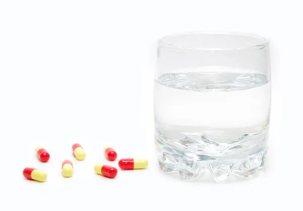 stock image Pills and a glass of water