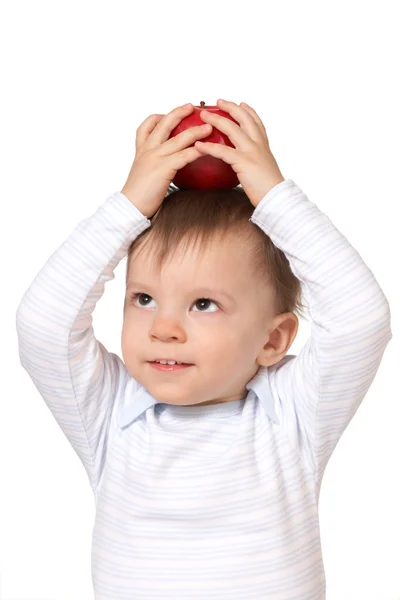 Smiling baby holding apple on the head — Stock Photo, Image