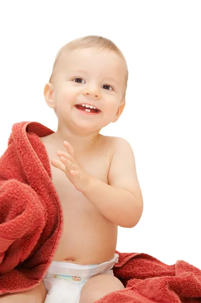 Baby in towel sitting on the floor — Stock Photo, Image