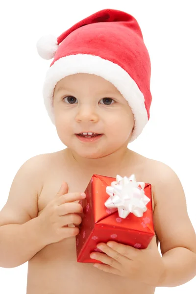 Baby in santa claus cap with gift — Stock Photo, Image