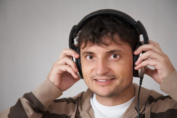 Young smiling man with headphones — Stock Photo, Image