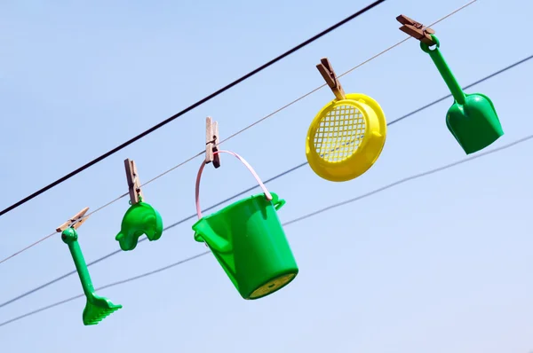 Child's toys on the clothesline — Stock Photo, Image