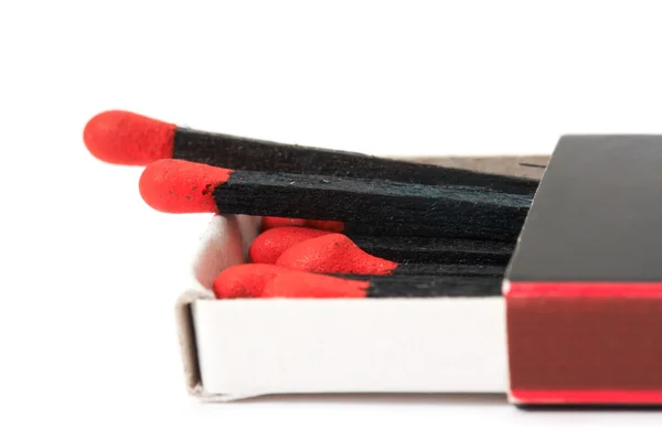 Black matches in matchbox — Stock Photo, Image