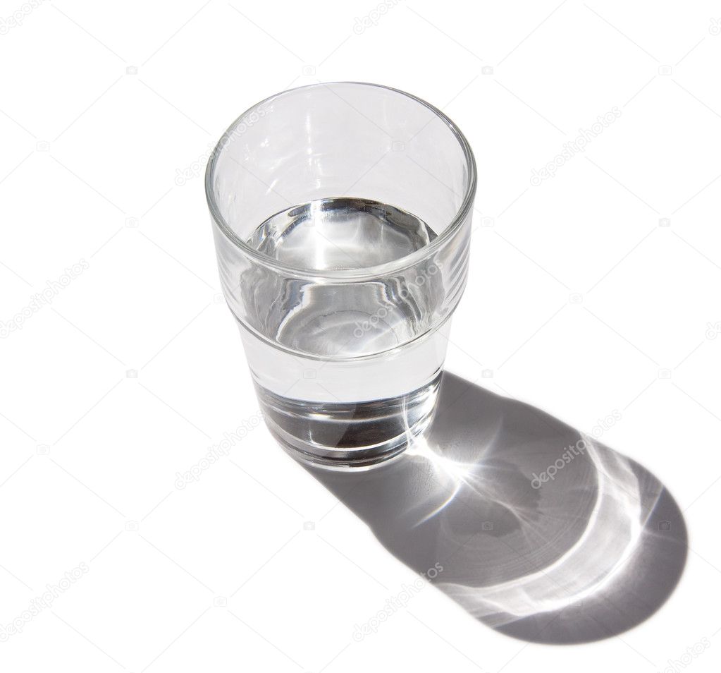 Half full glass of water with shadow