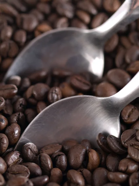 Coffee beans and spoons — Stock Photo, Image