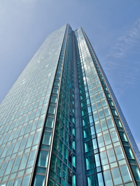 Modern glass skycraper under blue sky