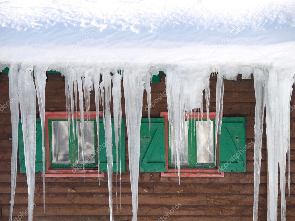 Green wooden windows with ice