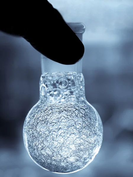 Chemist holding flask — Stock Photo, Image
