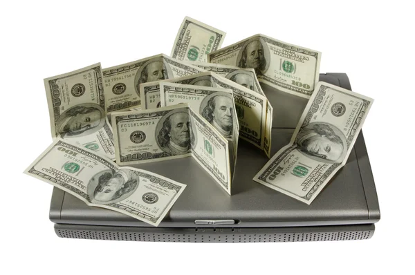 Доллары и ноутбук — стоковое фото