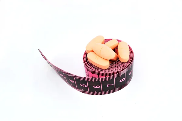 stock image Food supplements and a tape measure