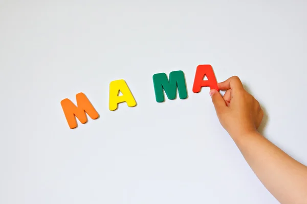 Kind hand schrijven word mama Stockfoto