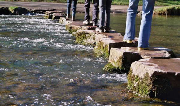 Crossing river on stepping stones