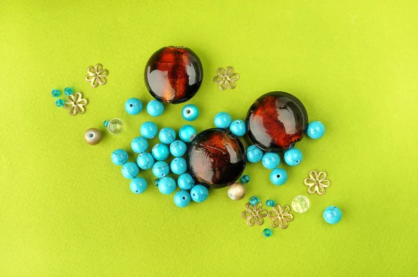 Brown beads among small beads — Stock Photo, Image