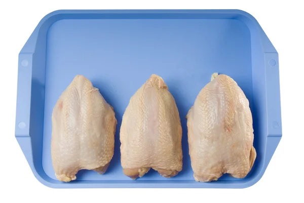 Stock image Three chicken breasts on a blue tray