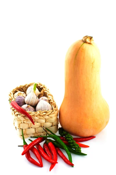 Basket of garlic, paprika and a pumpkin — Stock Photo, Image