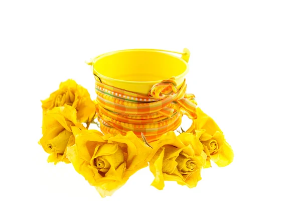 Dry yellow roses and bucket — Stock Photo, Image