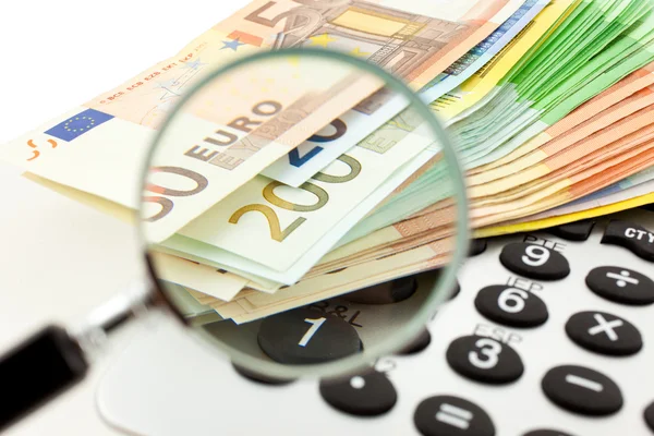 Euro with calculator and magnifier — Stock Photo, Image
