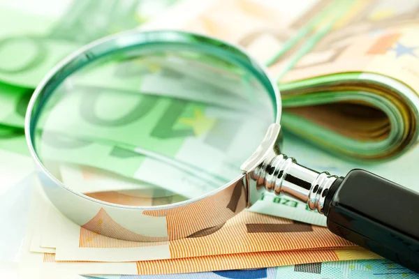 Euro notes with magnifier — Stock Photo, Image