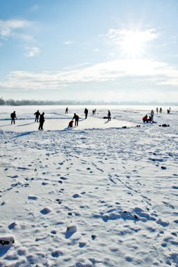 Skating on frozen lake clipart