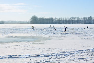 Ice-skating on frozen lake clipart