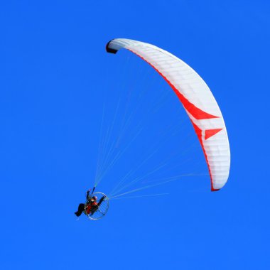 Motor powered paragliding clipart