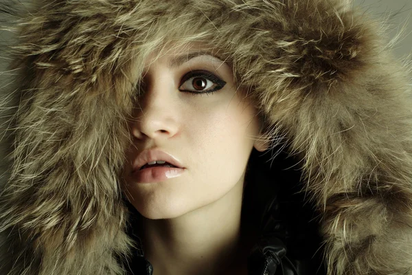 Young elegant girl with fur coat