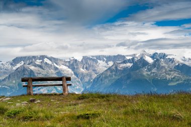 Empty park bench in high mountains