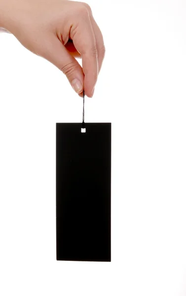 Etiqueta de papel negro y mano femenina — Foto de Stock