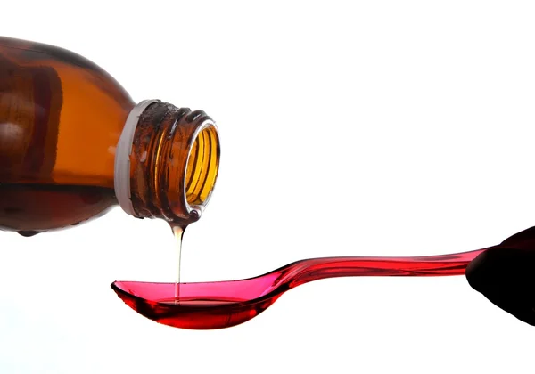 stock image Bottle with medicine and red spoon