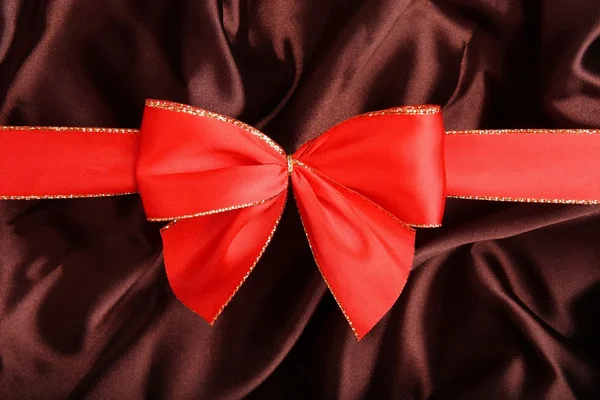 Red ribbon with brown smooth textile — Stock Photo, Image