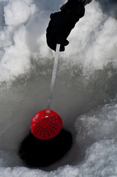 Cleaning out a hole for ice fishing — Stock Photo, Image