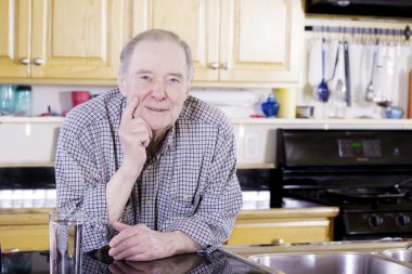 Elderly man leaning on counter clipart