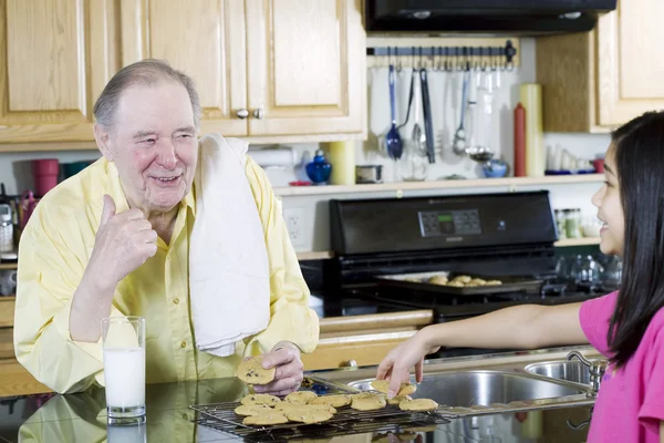 Elderly man sharing cookies — Stock Photo, Image