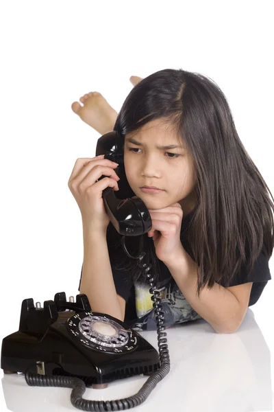 Girl talking on rotary phone, worried — Stock Photo, Image