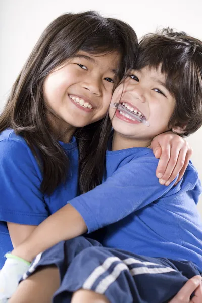 stock image Sister holding her disabled brother