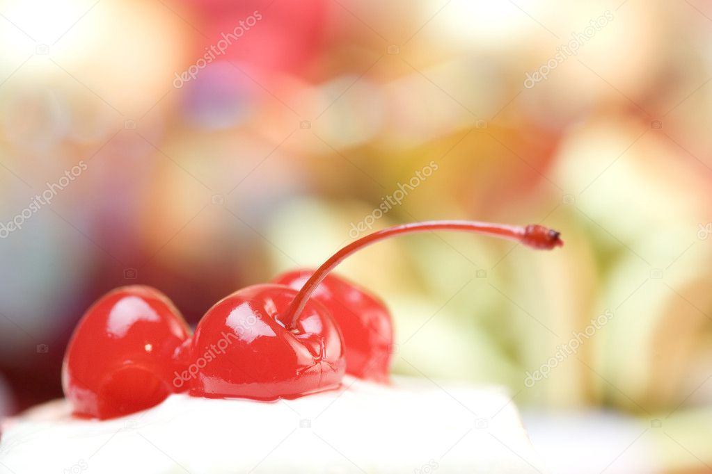 Cherries on top of frosted cake
