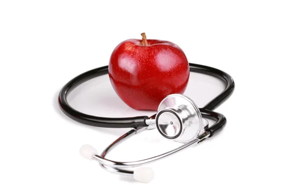 Красное яблоко со стетоскопом — стоковое фото