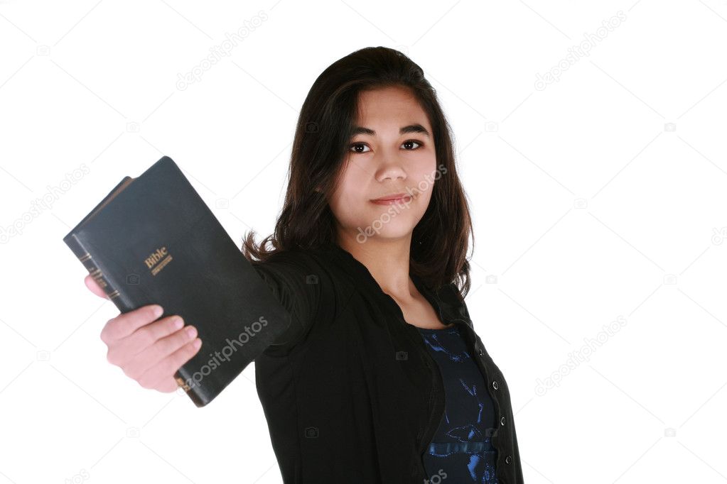 Teen girl holding out Bible