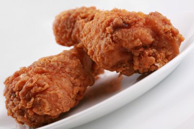 Two crispy fried chicken drumsticks clipart