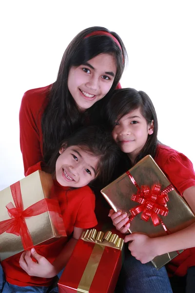 Three sisters holding presents — Zdjęcie stockowe